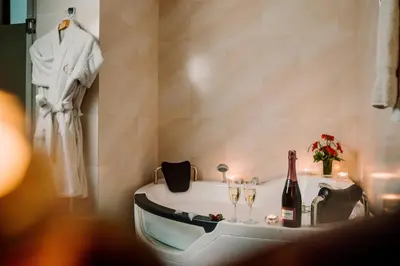 a bathroom with a bath tub with a bottle of wine at Hotel Nobility in Lima