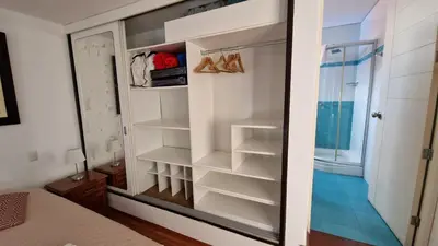 a walk in closet with white shelves and a glass door at MALECÓN BALTA 758 - Miraflores in Lima