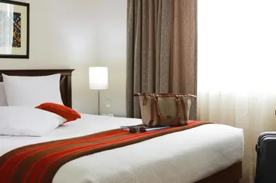 a hotel room with a bed with a bag on it at San Agustin Exclusive in Lima