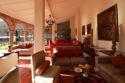 a living room with couches and a dining room at San Agustin Monasterio de la Recoleta in Urubamba
