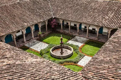 an aerial view of a courtyard in a building with a fountain at San Agustin Monasterio de la Recoleta in Urubamba