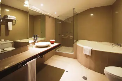 a bathroom with a sink and a tub and a toilet at San Agustin El Dorado in Cusco
