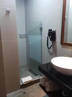 a bathroom with a glass shower and a sink at Hotel Sueños del Inka in Cusco