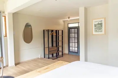 a room with a bed and a mirror at Tariq Sacred Valley in Urubamba