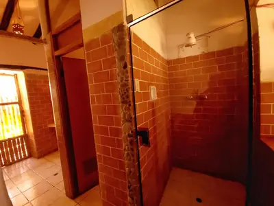 a bathroom with a shower with red tile at Casa de campo Yoga Retreat in Urubamba