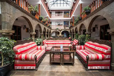 a group of couches and a table in a building at Munay Wasi Inn in Cusco