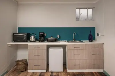 a kitchen with a sink and a refrigerator at Inkarri Cusco in Cusco