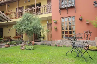 a yard in front of a pink building with a table at 