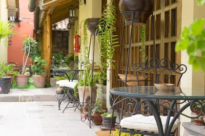 a patio with tables and chairs and potted plants at 