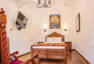 a bedroom with a bed and a tv on the wall at Amaru Inca in Cusco