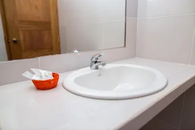 a bathroom counter with a sink and a mirror at Hosteria de Anita in Cusco