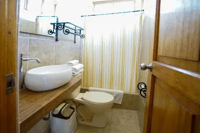 a bathroom with a white sink and a toilet at Amaru Valle Hotel in Urubamba