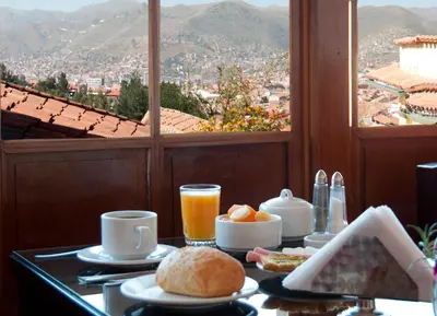 a breakfast table with a view of a city at Amaru Colonial in Cusco