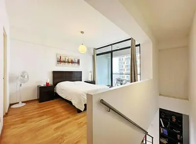 a bedroom with a bed and a large window at Apartamento dúplex exclusivo y céntrico in Lima