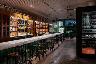 a bar with chairs and bottles of wine at Hyatt Centric San Isidro Lima in Lima