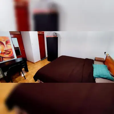 a bedroom with a bed and a desk with a painting at Antarki Apartment in Cusco