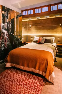 a bedroom with a large bed and a rug at Casa Azul in Lima