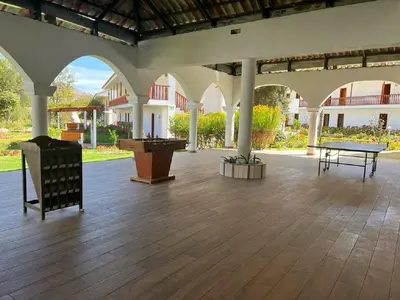 a large patio with a ping pong table in the middle at Hotel Agustos Urubamba in Urubamba
