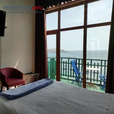 a bedroom with a bed and a view of the ocean at Second Home Peru in Lima