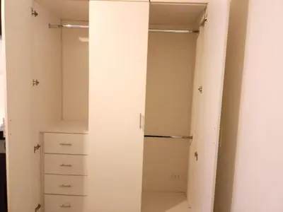 a walk in closet with white walls and a cabinet at In the heart of Lima in Lima