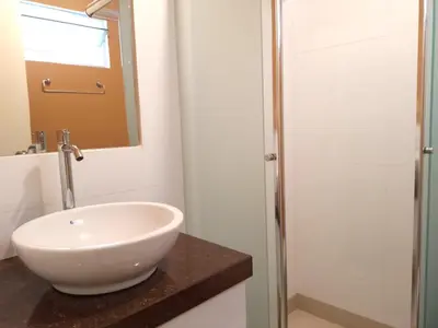 a bathroom with a white sink and a shower at In the heart of Lima in Lima