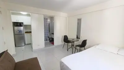 a bedroom with a bed and a table and chairs at In the heart of Lima in Lima