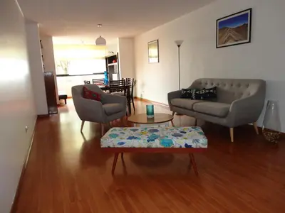 a living room with a couch and a table at Miraflores Bello Apartamento in Lima