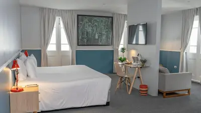 a bedroom with a large white bed and a desk at Casa Republica Barranco Boutique Hotel in Lima