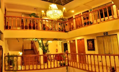 a large building with a chandelier and a staircase at Awki´s Dream Hotel in Cusco