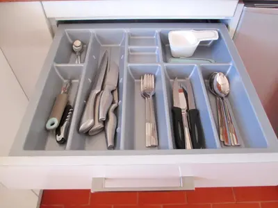 a tray filled with silver utensils in a drawer at Quinua Boutique Apartments in Cusco