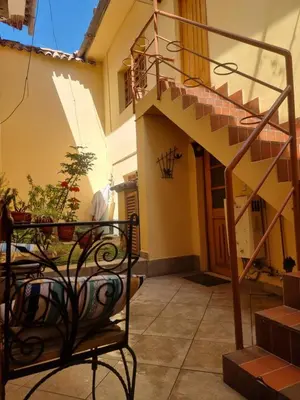 a balcony of a house with a spiral staircase at Departamentos Cusco in Cusco