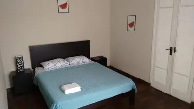 a bedroom with a bed with a blue comforter at Cozy and Comfortable Home in MIRAFLORES in Lima