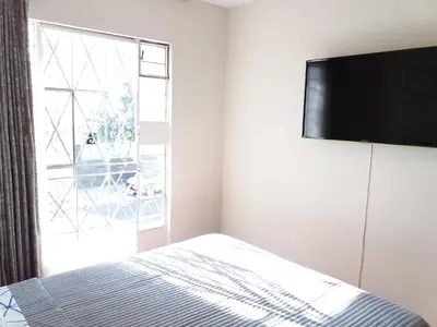 a bedroom with a bed and a large window at Cozy and Comfortable Home in MIRAFLORES in Lima