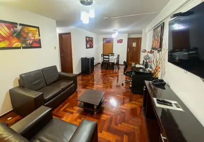 a living room with a couch and a table at Inkari Apart Hotel in Lima