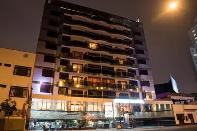 a tall building at night with lights at Inkari Apart Hotel in Lima