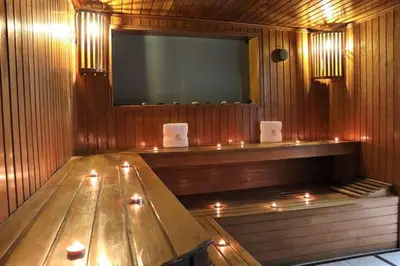a sauna with a wooden table and a large screen at Inkari Apart Hotel in Lima