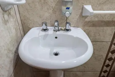 a bathroom with a white sink in a bathroom at Espacioso confortable apartamento familia in Cusco