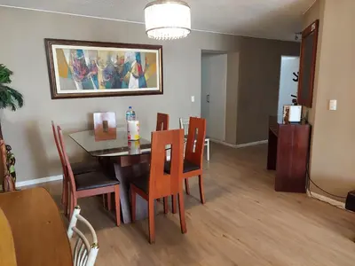 a dining room with a table and chairs at Apartamento PARDO CCA in Lima