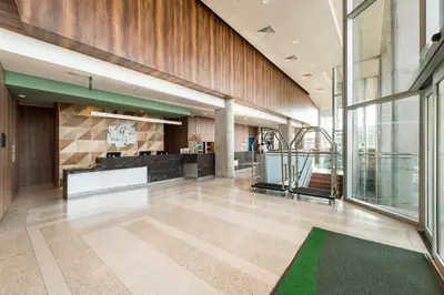 a lobby of a building with a green rug at Holiday Inn - Lima Airport by IHG in Lima