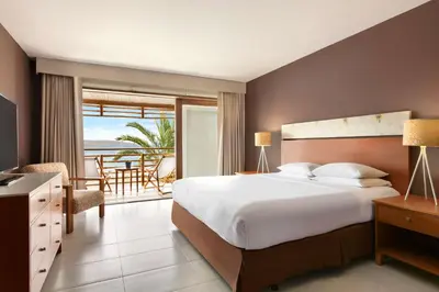 a bedroom with a bed and a view of the ocean at The Legend Paracas Resort, a Destination by Hyatt Hotel in Paracas
