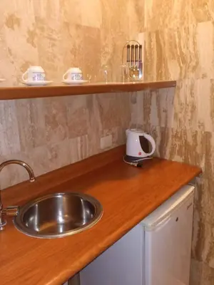 a kitchen with a sink and a counter top at Hotel Carmel in Lima