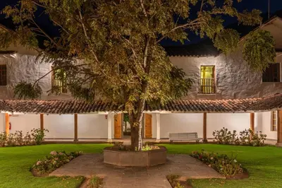 a house with a tree in front of it at Hotel La Casona De Yucay Valle Sagrado in Urubamba