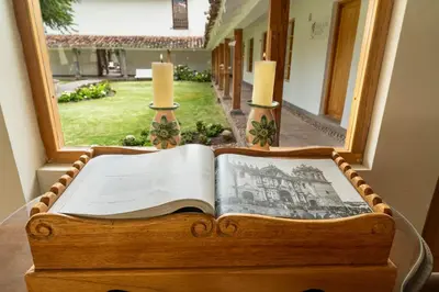 an open book sitting on a table next to a window at Hotel La Casona De Yucay Valle Sagrado in Urubamba