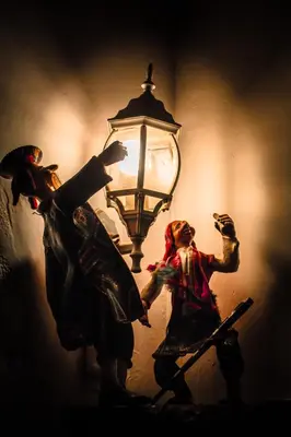 a lamp with two figurines standing next to it at SAN BLAS PLAZA INn in Cusco