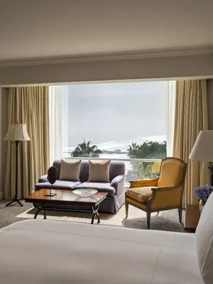a living room with a couch and chairs and a large window at Miraflores Park, A Belmond Hotel, Lima in Lima