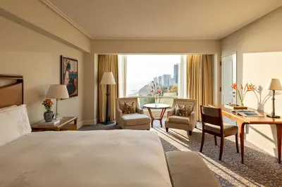 a hotel room with a large bed and a desk at Miraflores Park, A Belmond Hotel, Lima in Lima