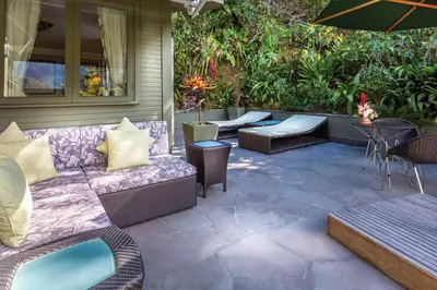 a patio with a couch and chairs and a table at Sanctuary Lodge, A Belmond Hotel, Machu Picchu in Machu Picchu