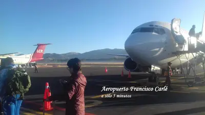 a group of people looking at an airplane on the runway at Pousada Villa Huaripampa in Jauja