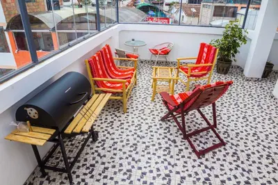 a balcony with chairs and a table on a balcony at Boutique Amaru Wasi in Cusco