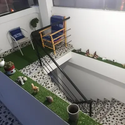 a room with a balcony with a bench and some plants at Boutique Amaru Wasi in Cusco